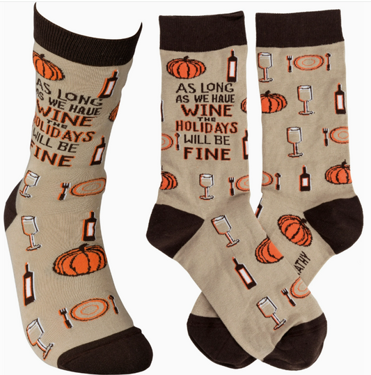 A pair of whimsical socks that read All wine is fine, ideal for adding humor to any outfit.