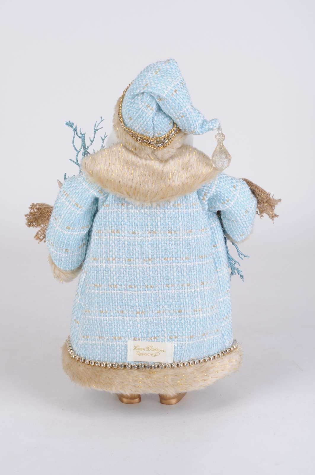 Coastal Shell Swag Santa figurine in a blue coat and hat, adorned with seaside-inspired accents.