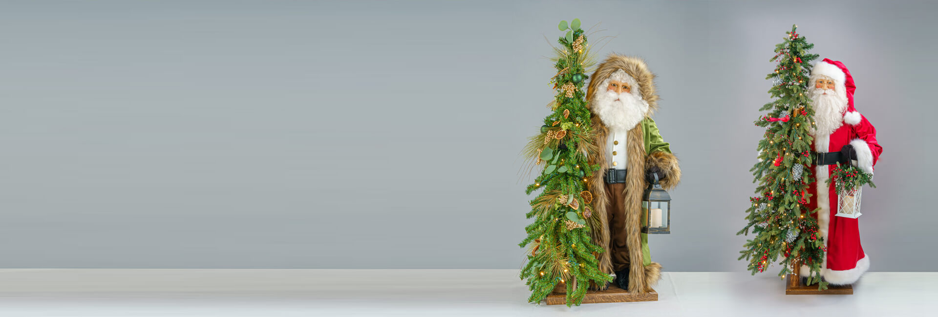 Two Santa Clauses next to each other, each wearing a classic red outfit with white accents and black boots.