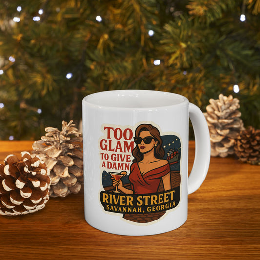 A sleek white mug featuring the bold phrase “Too Glam to Give A Damn!” in eye-catching, modern typography.